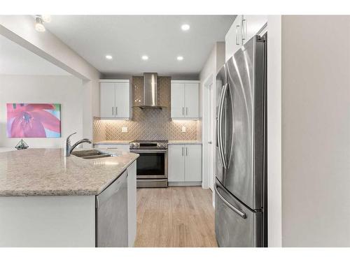 230 Hillcrest Square Sw, Airdrie, AB - Indoor Photo Showing Kitchen With Double Sink With Upgraded Kitchen