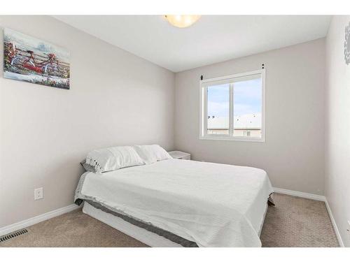 230 Hillcrest Square Sw, Airdrie, AB - Indoor Photo Showing Bedroom