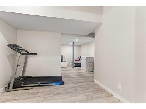 230 Hillcrest Square Sw, Airdrie, AB - Indoor Photo Showing Gym Room