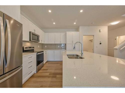 325 Baneberry Way Sw, Airdrie, AB - Indoor Photo Showing Kitchen With Stainless Steel Kitchen With Double Sink With Upgraded Kitchen