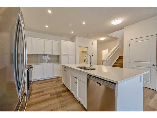 325 Baneberry Way Sw, Airdrie, AB - Indoor Photo Showing Kitchen With Stainless Steel Kitchen With Double Sink With Upgraded Kitchen