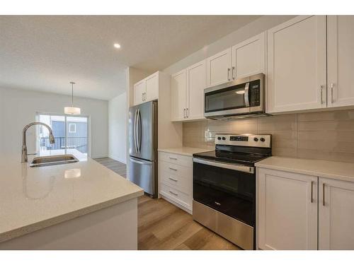 325 Baneberry Way Sw, Airdrie, AB - Indoor Photo Showing Kitchen With Stainless Steel Kitchen With Double Sink