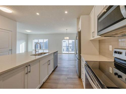 325 Baneberry Way Sw, Airdrie, AB - Indoor Photo Showing Kitchen With Double Sink