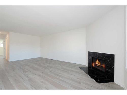 5137 17 Avenue Nw, Calgary, AB - Indoor Photo Showing Other Room With Fireplace