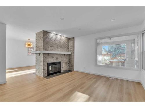 116 Strathcona Close Sw, Calgary, AB - Indoor Photo Showing Living Room With Fireplace