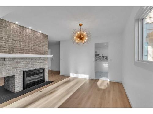 116 Strathcona Close Sw, Calgary, AB - Indoor Photo Showing Living Room With Fireplace