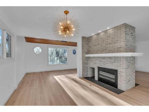 116 Strathcona Close Sw, Calgary, AB - Indoor Photo Showing Living Room With Fireplace