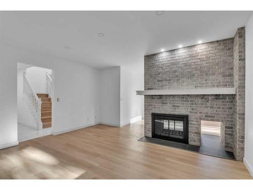 116 Strathcona Close Sw, Calgary, AB - Indoor Photo Showing Living Room With Fireplace