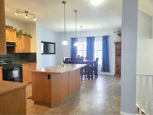 2398 Sagewood Crescent Sw, Airdrie, AB - Indoor Photo Showing Kitchen With Double Sink