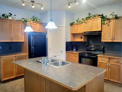 2398 Sagewood Crescent Sw, Airdrie, AB - Indoor Photo Showing Kitchen With Double Sink