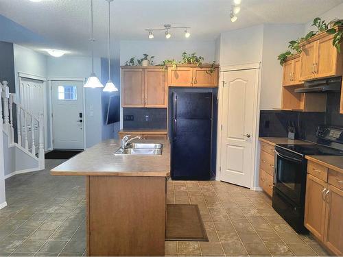 2398 Sagewood Crescent Sw, Airdrie, AB - Indoor Photo Showing Kitchen With Double Sink