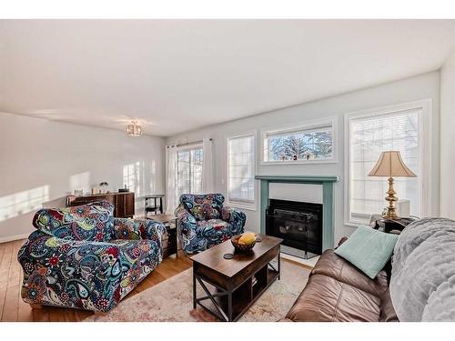 21-12 Silver Creek Boulevard Nw, Airdrie, AB - Indoor Photo Showing Living Room With Fireplace