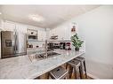 21-12 Silver Creek Boulevard Nw, Airdrie, AB  - Indoor Photo Showing Kitchen With Double Sink 