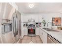 21-12 Silver Creek Boulevard Nw, Airdrie, AB  - Indoor Photo Showing Kitchen With Double Sink 