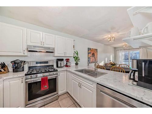 21-12 Silver Creek Boulevard Nw, Airdrie, AB - Indoor Photo Showing Kitchen With Double Sink