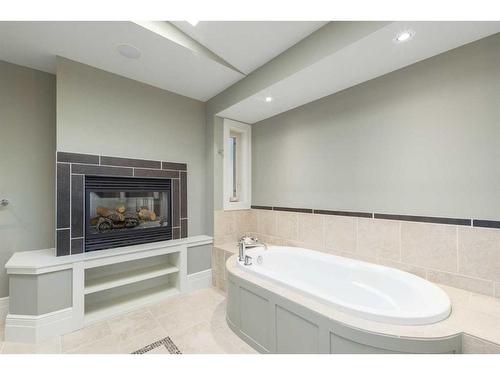 31 Aspen Meadows Green Sw, Calgary, AB - Indoor Photo Showing Bathroom With Fireplace