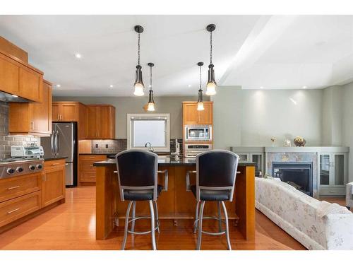 31 Aspen Meadows Green Sw, Calgary, AB - Indoor Photo Showing Kitchen With Fireplace