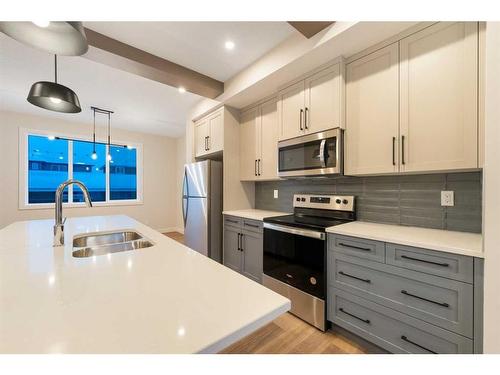 1199 Lanark Boulevard, Airdrie, AB - Indoor Photo Showing Kitchen With Double Sink With Upgraded Kitchen