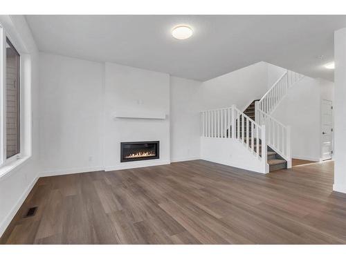 242 Baneberry Way Sw, Airdrie, AB - Indoor Photo Showing Living Room With Fireplace