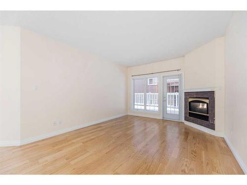 102-820 15 Avenue Sw, Calgary, AB - Indoor Photo Showing Other Room With Fireplace