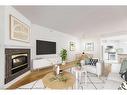 102-820 15 Avenue Sw, Calgary, AB  - Indoor Photo Showing Living Room With Fireplace 