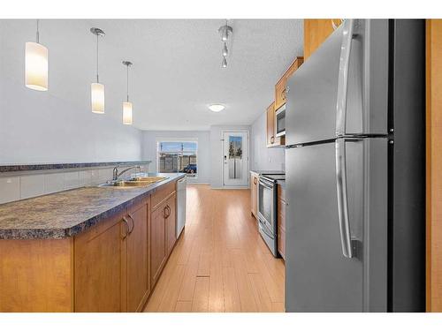 2105-700 Willowbrook Road Nw, Airdrie, AB - Indoor Photo Showing Kitchen With Stainless Steel Kitchen With Double Sink