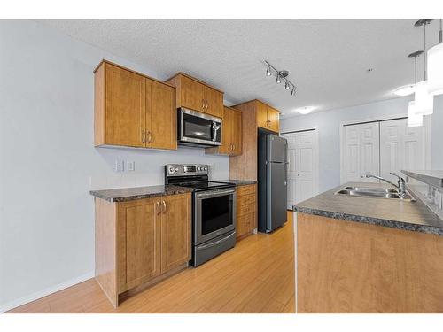 2105-700 Willowbrook Road Nw, Airdrie, AB - Indoor Photo Showing Kitchen With Stainless Steel Kitchen With Double Sink