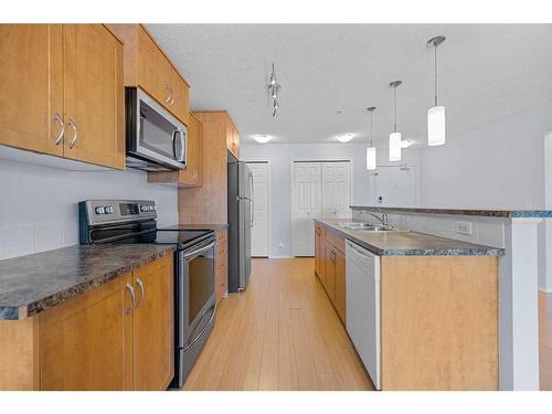 2105-700 Willowbrook Road Nw, Airdrie, AB - Indoor Photo Showing Kitchen With Stainless Steel Kitchen With Upgraded Kitchen