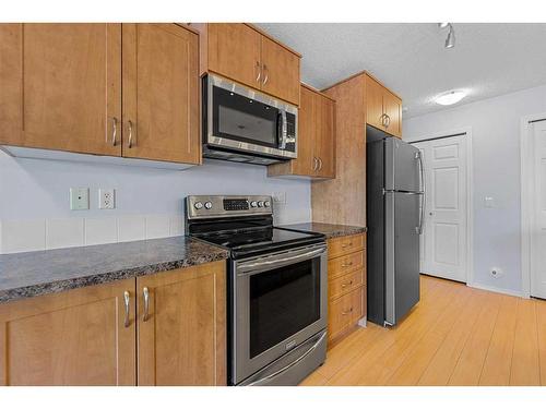 2105-700 Willowbrook Road Nw, Airdrie, AB - Indoor Photo Showing Kitchen