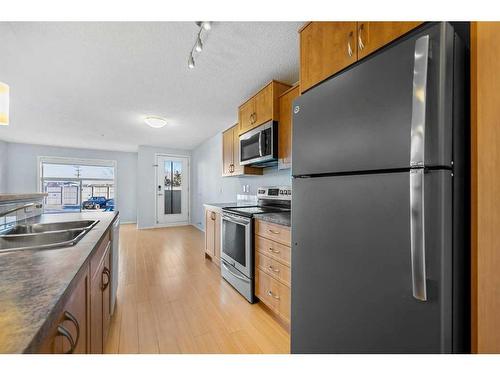 2105-700 Willowbrook Road Nw, Airdrie, AB - Indoor Photo Showing Kitchen With Stainless Steel Kitchen With Double Sink