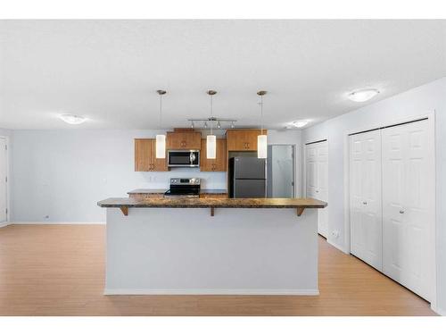 2105-700 Willowbrook Road Nw, Airdrie, AB - Indoor Photo Showing Kitchen