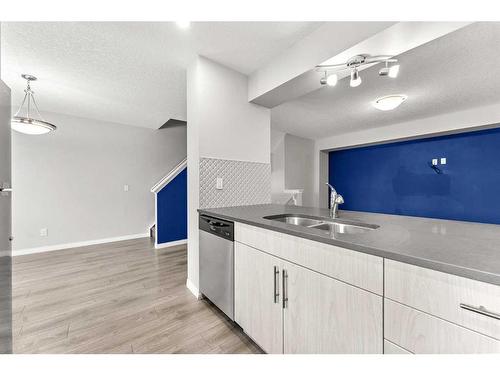 350 Hillcrest Square Sw, Airdrie, AB - Indoor Photo Showing Kitchen With Double Sink