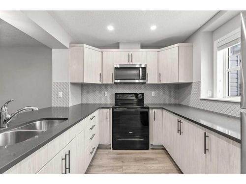 350 Hillcrest Square Sw, Airdrie, AB - Indoor Photo Showing Kitchen With Double Sink