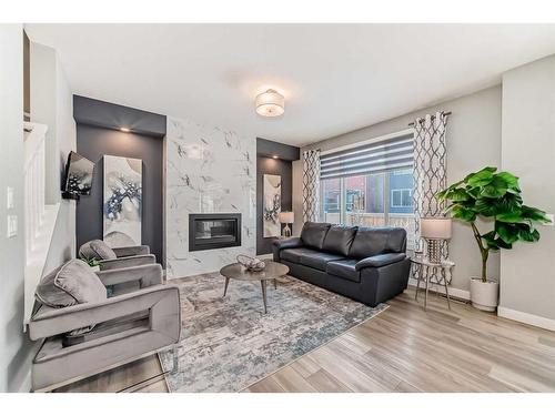 136 Creekstone Square Sw, Calgary, AB - Indoor Photo Showing Living Room With Fireplace