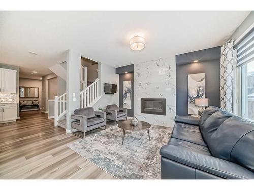 136 Creekstone Square Sw, Calgary, AB - Indoor Photo Showing Living Room With Fireplace