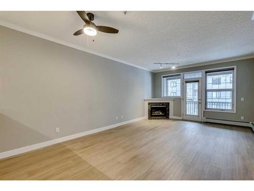 208-495 78 Avenue Sw, Calgary, AB - Indoor Photo Showing Other Room With Fireplace