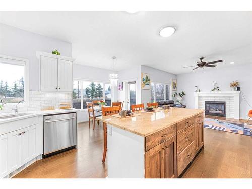 108 West Pointe Manor, Cochrane, AB - Indoor Photo Showing Kitchen With Fireplace