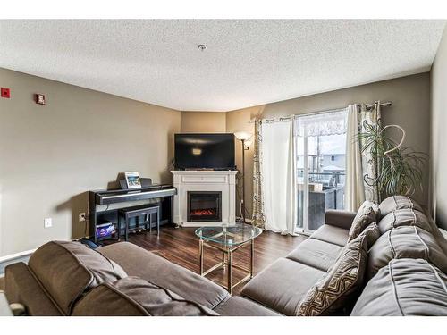 3204-Tuscarora Tuscarora Manor Nw, Calgary, AB - Indoor Photo Showing Living Room With Fireplace