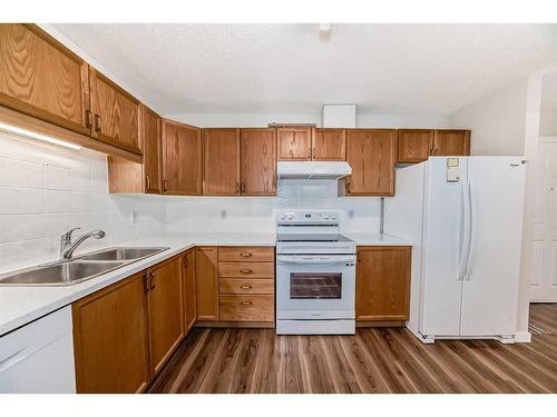 1313-928 Arbour Lake Road Nw, Calgary, AB - Indoor Photo Showing Kitchen With Double Sink