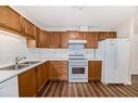 1313-928 Arbour Lake Road Nw, Calgary, AB  - Indoor Photo Showing Kitchen With Double Sink 