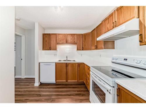 1313-928 Arbour Lake Road Nw, Calgary, AB - Indoor Photo Showing Kitchen With Double Sink