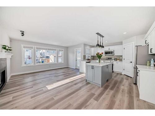 1180 Kings Heights Road Se, Airdrie, AB - Indoor Photo Showing Kitchen With Fireplace