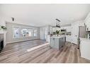 1180 Kings Heights Road Se, Airdrie, AB  - Indoor Photo Showing Kitchen With Fireplace 