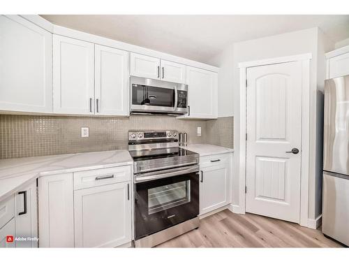 1180 Kings Heights Road Se, Airdrie, AB - Indoor Photo Showing Kitchen With Stainless Steel Kitchen