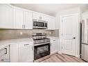 1180 Kings Heights Road Se, Airdrie, AB  - Indoor Photo Showing Kitchen With Stainless Steel Kitchen 