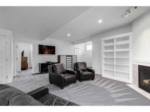 110 Cougarstone Terrace Sw, Calgary, AB - Indoor Photo Showing Living Room With Fireplace