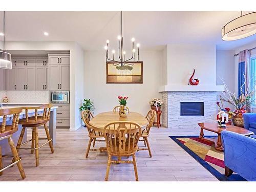 565 Marine Drive Se, Calgary, AB - Indoor Photo Showing Dining Room With Fireplace