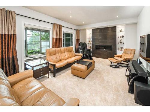 16 Silver Creek Place Nw, Calgary, AB - Indoor Photo Showing Living Room With Fireplace