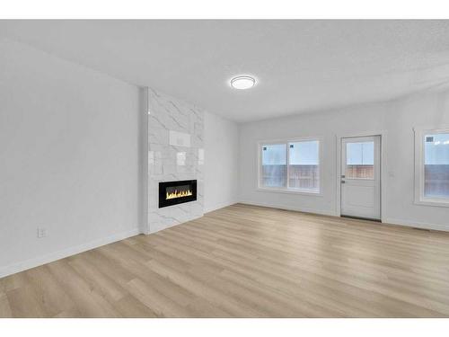 525 Corner Meadows Way Ne, Calgary, AB - Indoor Photo Showing Living Room With Fireplace