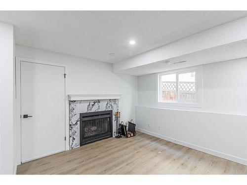 122 Sandstone Drive Nw, Calgary, AB - Indoor Photo Showing Living Room With Fireplace